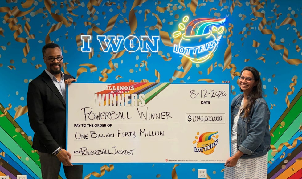 Illinois Lottery Director, Harold Mays (left), and Chicago Prize Center manager
Amanda Crosas...
